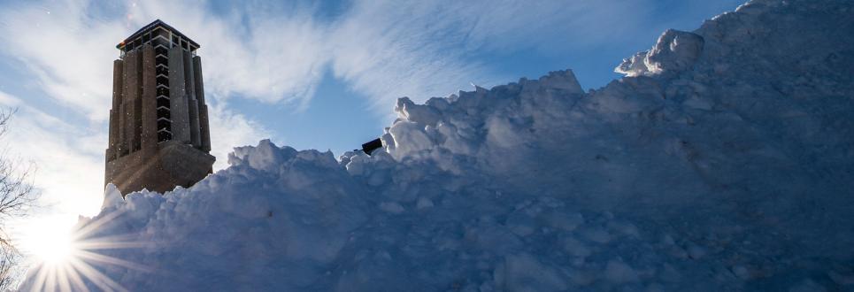 A pile of snow with Burton Tower in the background