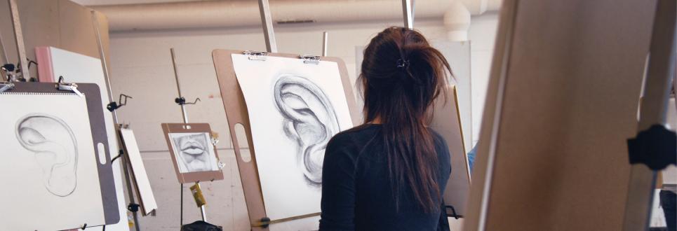 A student drawing an ear in an art class