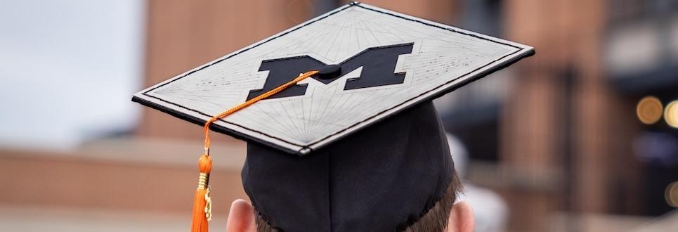 Graduate with Block-M decoration on their square graduation cap.